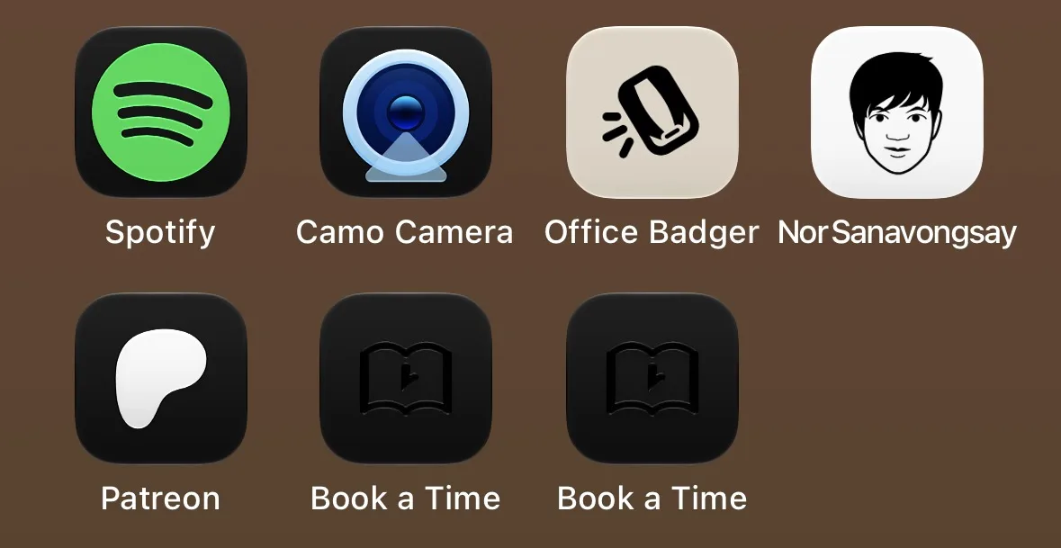 Home screen in dark mode: two black Book a Time icons beside the Office Badger and site icons